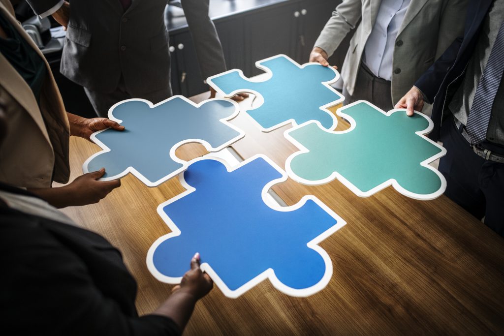 Business people connecting puzzle pieces